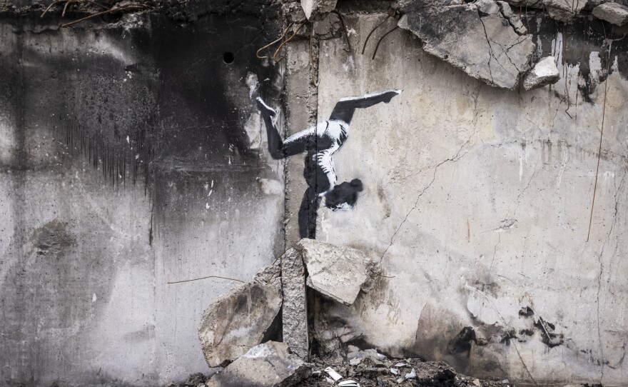 Graffiti of a woman in a leotard doing a handstand is seen on the wall of a destroyed building in Borodyanka on Friday in Kyiv Region, Ukraine. Banksy later confirmed on their Instagram account that this piece was their work.