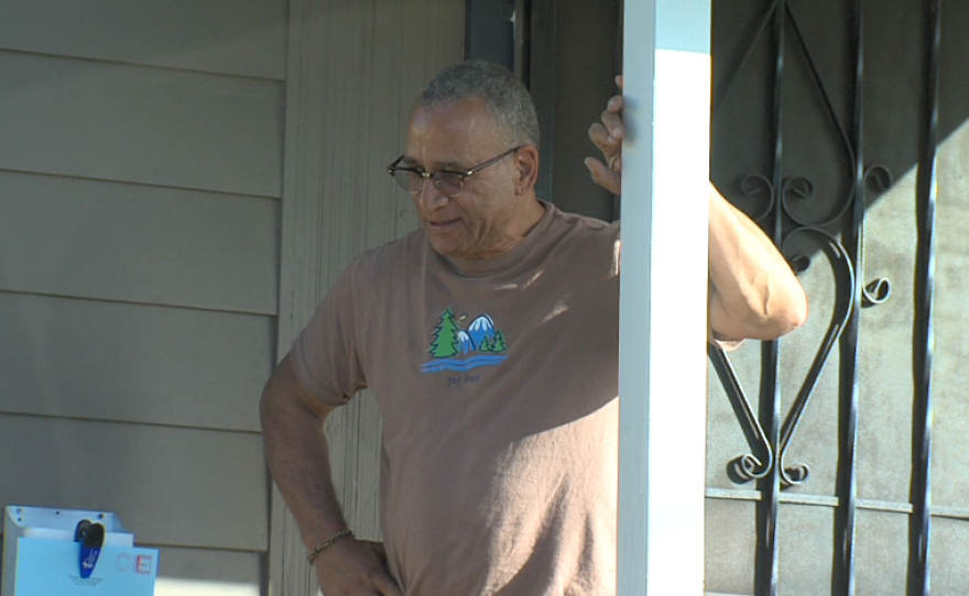 Barry Pollard stands on the porch of his Southeast San Diego home.