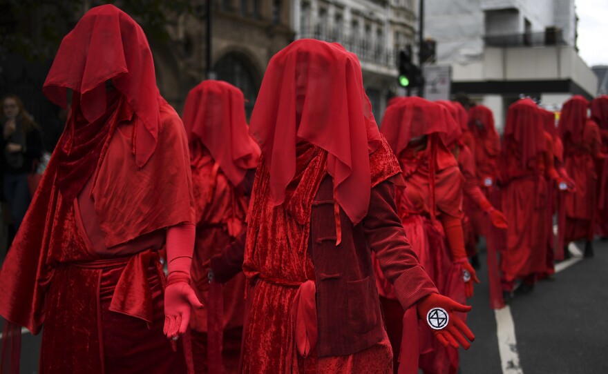 Climate activists take part in a demonstration Monday in London, where police say they've arrested dozens of protesters as the Extinction Rebellion group attempts to draw attention to climate change.