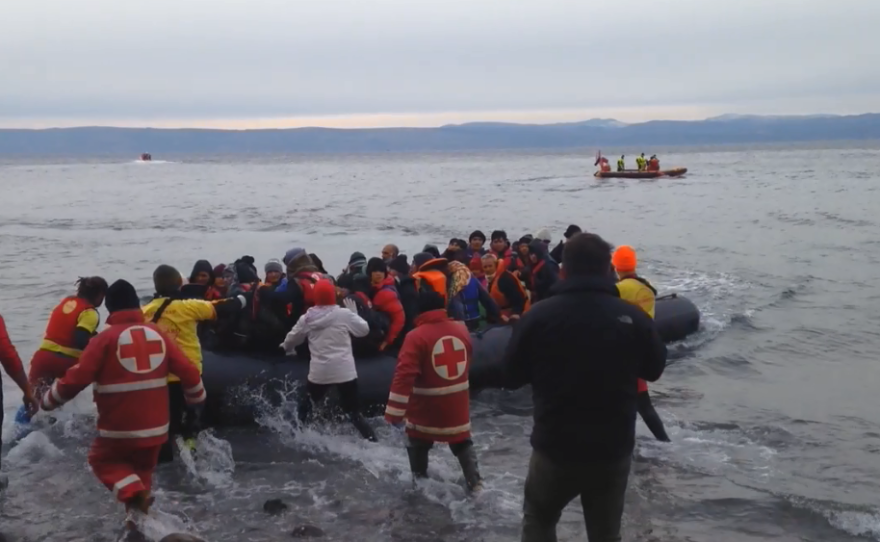 Migrants from Afghanistan arrive on a rocky beach in northern Lesbos, assisted by Greek Red Cross volunteers, Spanish lifeguards and other international volunteers.