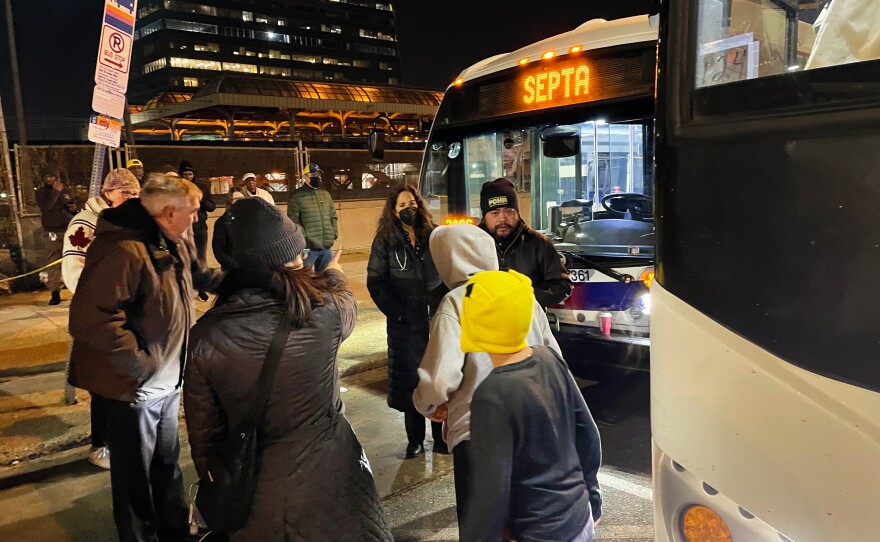 Passengers disembarking from a bus sent to Philadelphia by the state of Texas on December 5, 2022.