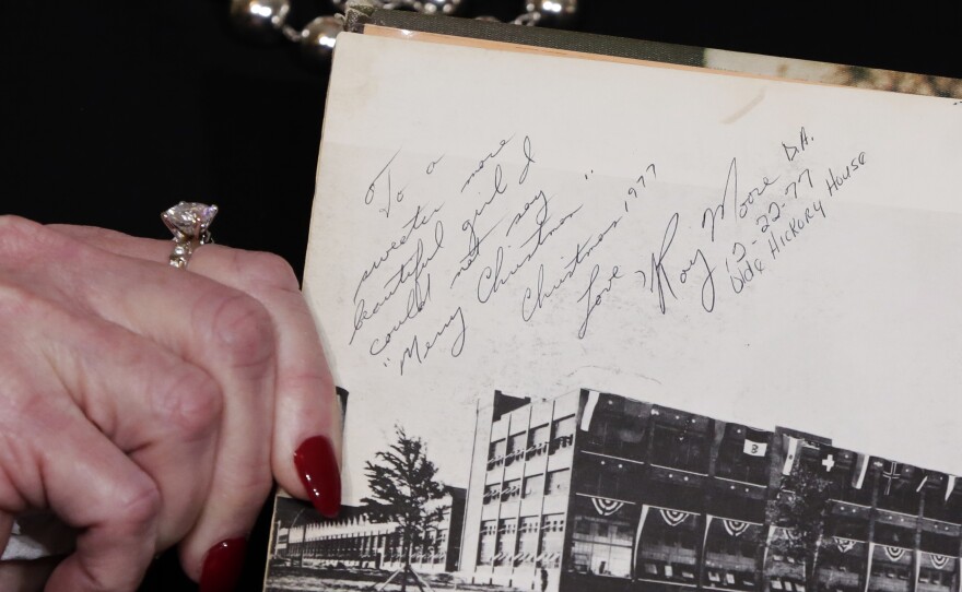 Nelson, one of several accusers of Alabama Republican Roy Moore, shows her high school yearbook she alleges was signed by Moore, at a news conference last month.