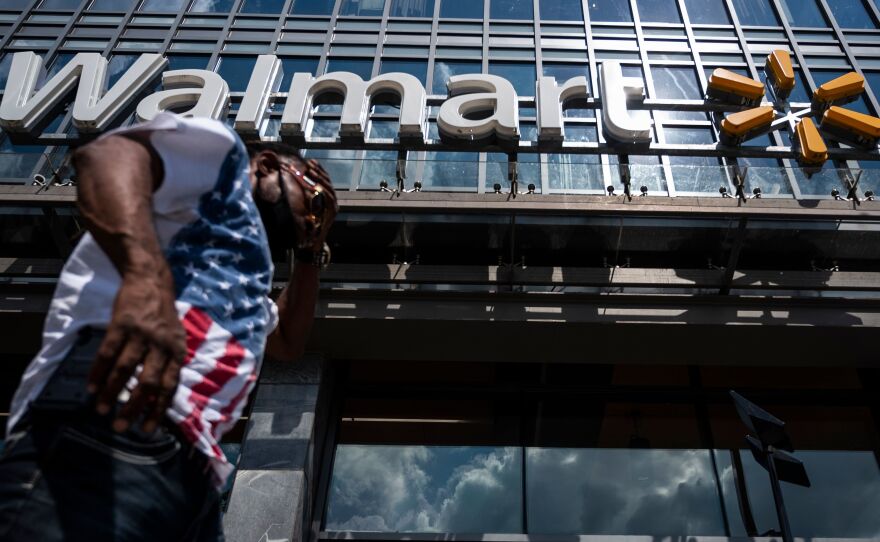 A man walks past a Walmart store in Washington, D.C. on July 15. Walmart said it was "confident" that its joint deal with Microsoft would satisfy both TikTok users and U.S. government regulators.