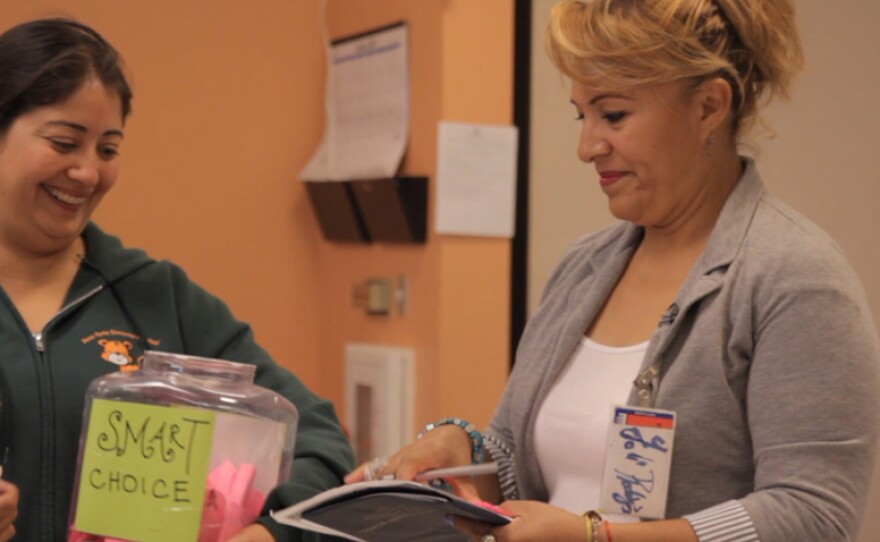 Yolanda Rodriguez sorts through nominations for Rosa Park Elementary's "Smart Choices" program, Nov. 5, 2014. The program encourages students to eat healthy and exercise by offering them raffle prizes.