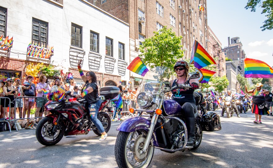 Participants pass in front of the Stonewall Inn during the New York City Pride parade.