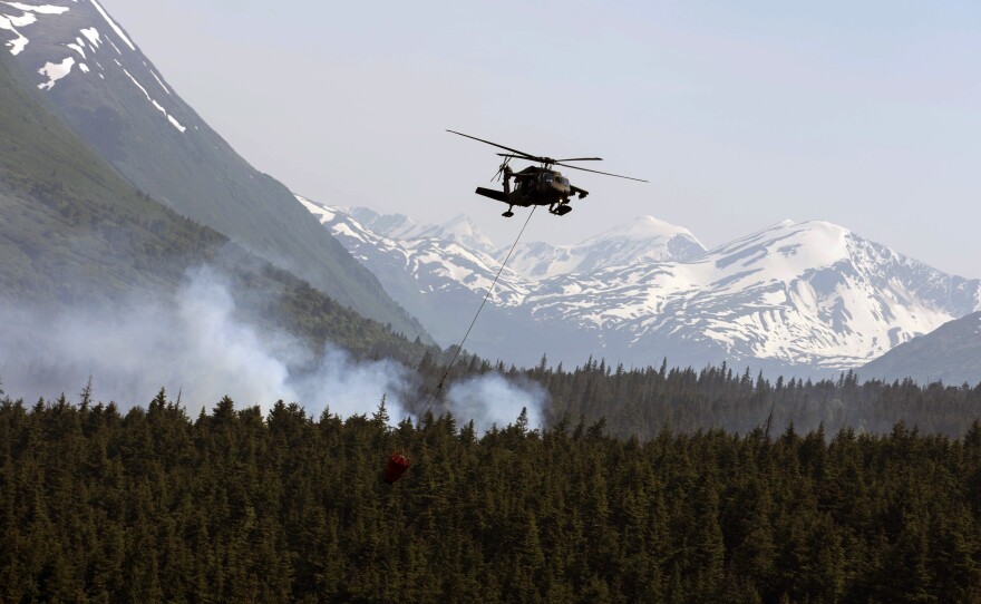 Some of Alaska's wildfires are dramatic: flames, vast plumes of smoke and firefighting battles. Here, on June 17, a helicopter releases hundreds of gallons of water onto the Stetson Creek Fire near Cooper Landing, Alaska. But even fires that look far quieter, like they're all burnt out, can continue to smolder underground — and pose a dangerous threat to permafrost.