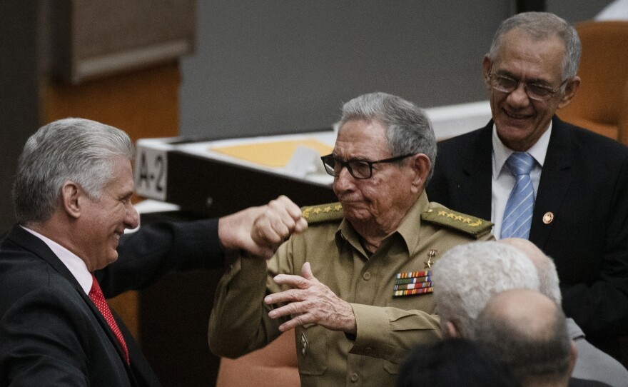 Raul Castro, first secretary of the Communist Party and former president, clasps hands with Cuban President Miguel Diaz-Canel during the closing session at the National Assembly of Popular Power in 2019 in Havana.