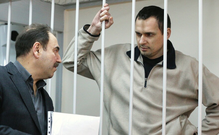 Ukrainian film director Oleg Sentsov (right), was arrested on charges of terrorism last year in Crimea shortly after Russia seized it from Ukraine. He's shown here at a hearing at Moscow's Lefortovo District Court on Dec. 26, 2014.
