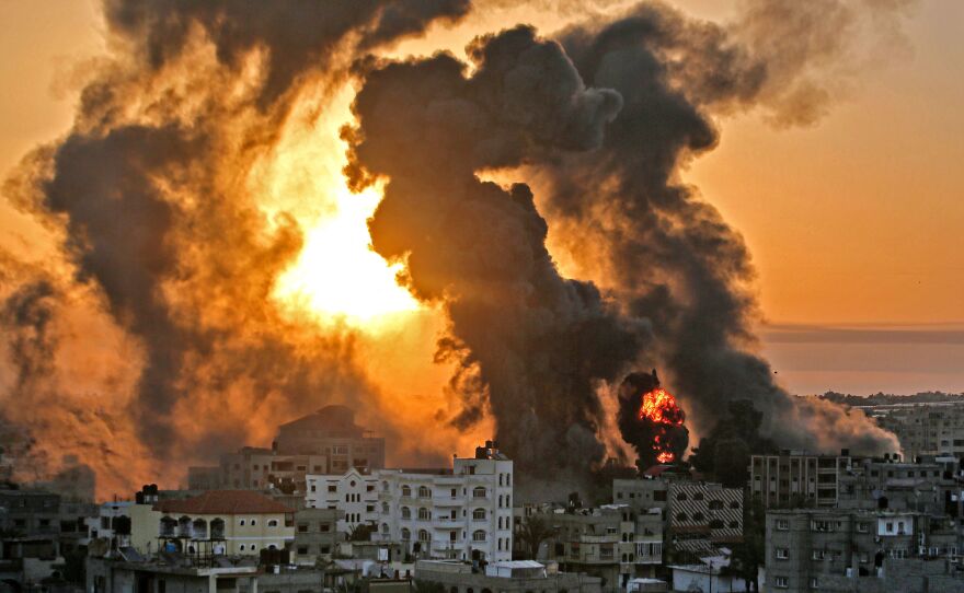 A fire rages at sunrise in Khan Yunis following an Israeli airstrike in the southern Gaza Strip, early on May 12.