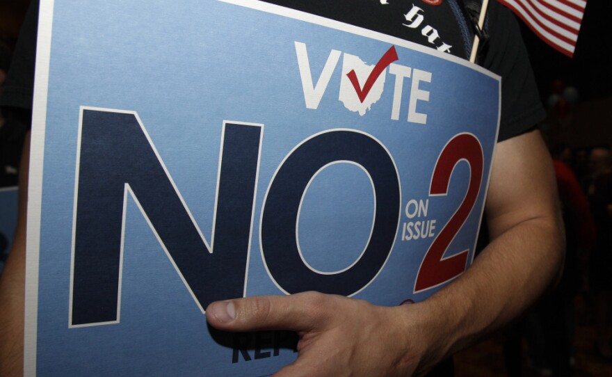 A supporter to repeal Senate Bill 5 holds onto his sign during a rally Tuesday in Columbus, Ohio. Ohio voters rejected a new law restricting the collective bargaining abilities of public employee unions in an unusually vigorous off-year election that drew attention across the nation.