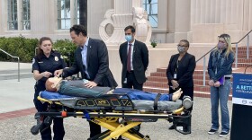 San Diego County Supervisor Nathan Fletcher demonstrates how to administer naloxone in front of the County Administration building in San Diego, Calif. May 21, 2021.