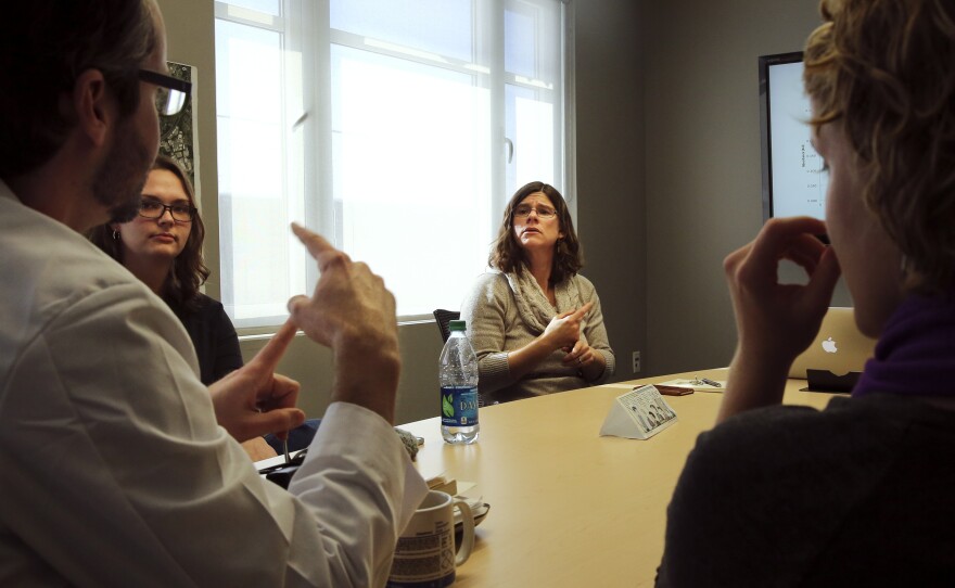 Solomon leads a biology lab discussion with students.