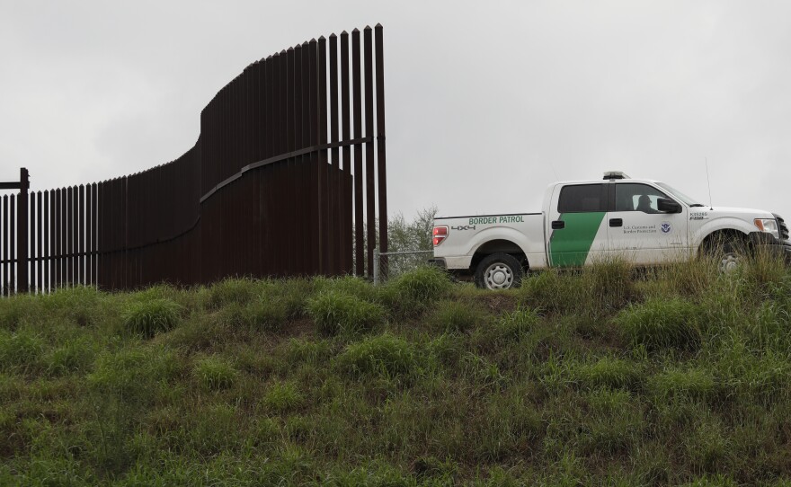 A U.S. Customs and Border Patrol agent passes along a section of border wall in Hidalgo, Texas.