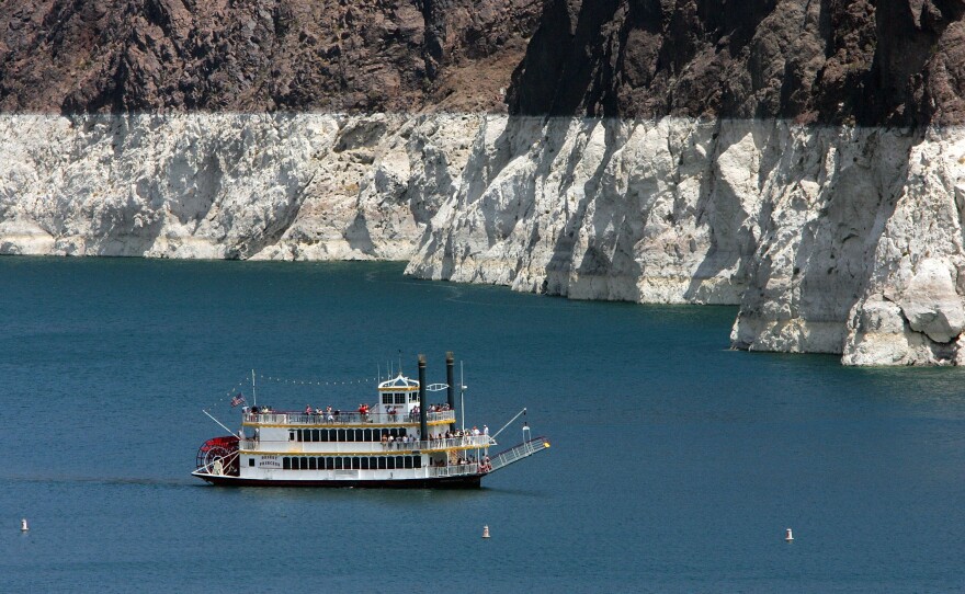 The white 'bathtub ring' on the rocks around Lake Mead is from mineral deposits left by higher levels of water. 