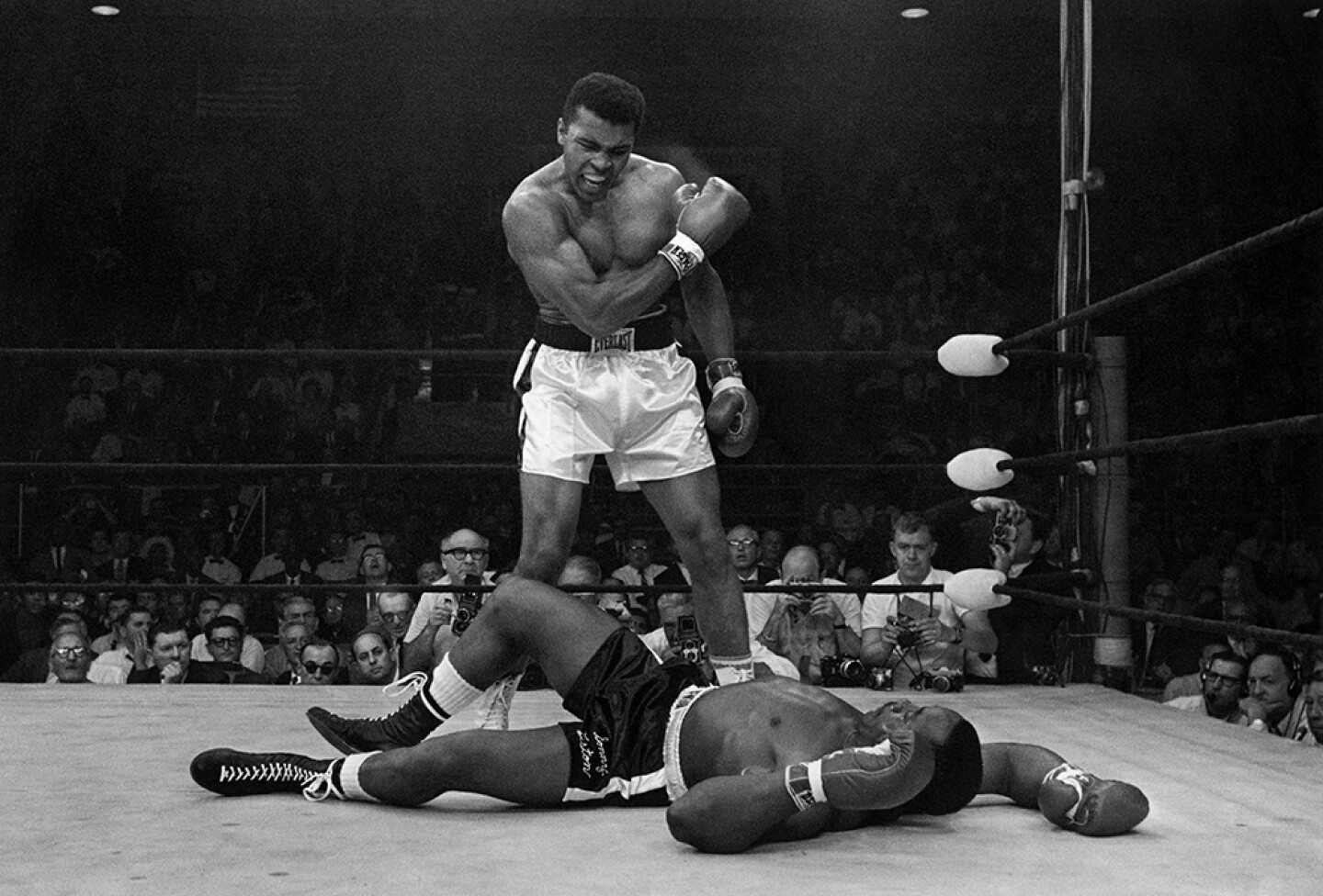 Muhammad Ali stands over fallen Sonny Liston, shouting and gesturing shortly after dropping Liston with a short hard right to the jaw in Lewiston, Maine. May 25, 1965.
