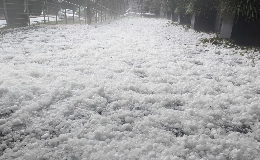 Golf-ball-sized hail carpets a street in Canberra on Monday, in a new twist on Australia's summer of extreme weather. The Australian Capital Territory's emergency service said it received a record number of calls for help — more than 1,900.