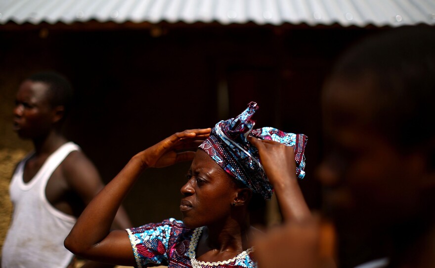 Adamsay Fofanah, center, lives in the village of Royail, which has been hit hard by the Ebola outbreak. His mother died the day before, most likely of the virus.