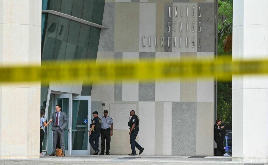 People walk in front of the Wilkie D. Ferguson Jr. United States Federal Courthouse in Miami on Monday, the day before former President Donald Trump is expected to appear for an arraignment regarding 37 federal charges against him.