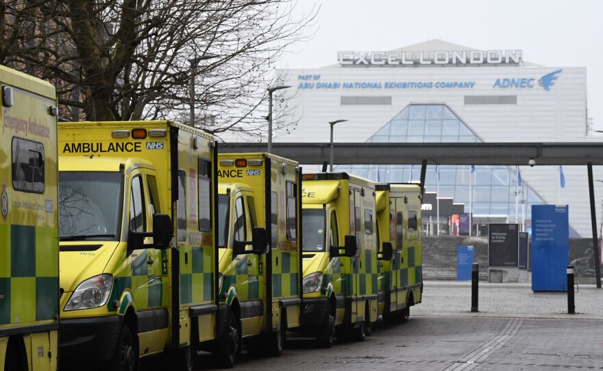 Ambulances are parked outside the NHS Nightingale hospital at the ExCeL center in east London on Friday. Hospitals in the U.K. are preparing for an influx of patients as the coronavirus continues to spread.