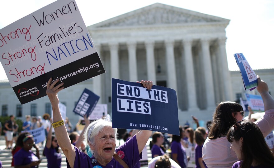 Abortion-rights proponents protest outside the U.S. Supreme Court on Tuesday. The retirement of Justice Anthony Kennedy set the stage for a battle over abortion rights unlike any in a generation.