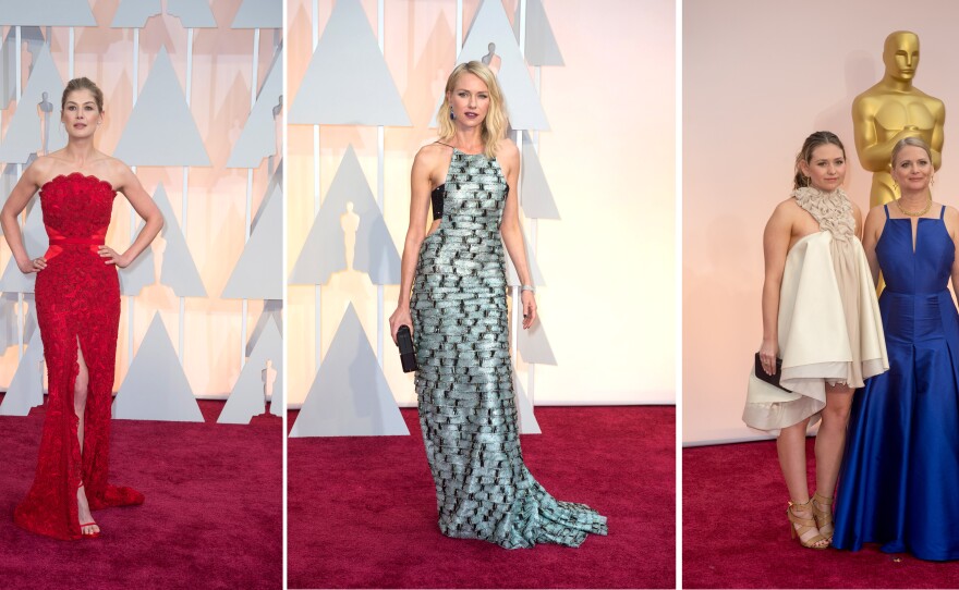 The good, the bad and the ugly at the 87th annual Academy Awards, Feb. 22, 2015. The good: Best Actress nominee Rosamund Pike, far left, looked stunning in one of the few dresses of color. The bad: Actress Naomi Watts, middle, looked like she was wearing a wall of silver bricks, and the ugly: "Boyhood's" producer Cathleen Sutherland and guest, far right, were a fashion nightmare.