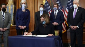 House Speaker Nancy Pelosi of Calif., signs the article of impeachment against President Donald Trump in an engrossment ceremony before transmission to the Senate for trial on Capitol Hill, in Washington, Wednesday, Jan. 13, 2021.