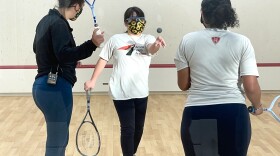Theresa Joy, 11, practicing her squash moves with Deon Saffery, Squash Manager at Access Youth Academy, and a classmate, Southeast San Diego, CA, January 26, 2022