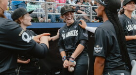 Brittany Apgar (from left), Maggie Foxx and Mo'ne Davis, of the Los Angeles Queens, joke around in the dugout prior to the start of the Women's Pro Baseball League's inaugural game in Springfield, Ill., on Saturday, Aug. 1.