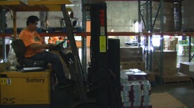 A worker loads food at the Feeding America San Diego distribution center, Sept. 4, 2014.