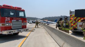 A light plane lands on the southbound I-5 near Via de la Valle in Del Mar, Aug. 24, 2021.