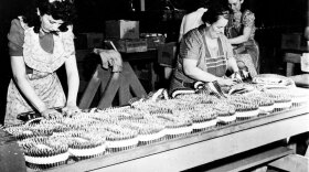 Workers pack bullets into machine gun belts in 1942. Factories like the one these women worked for used fringe benefits, including health insurance plans, to lure new employees in response to increased demand for goods during World War II.