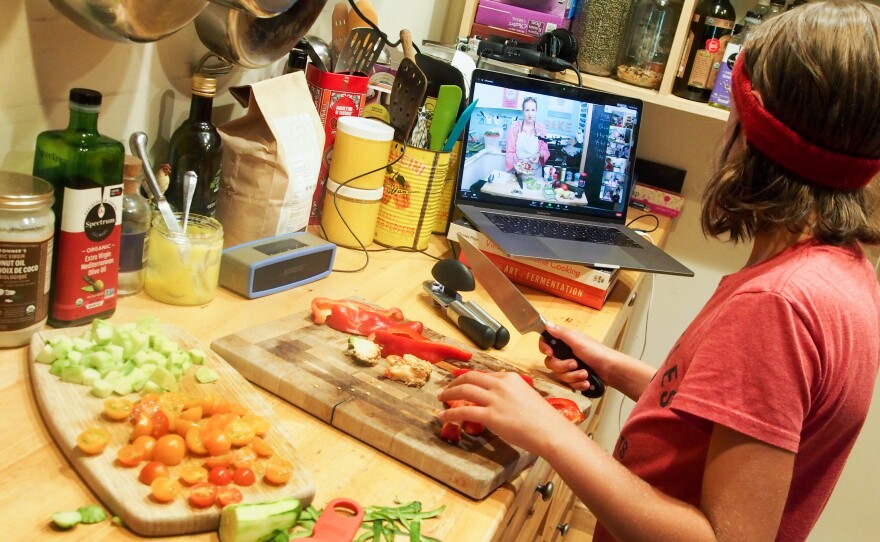 Wiley James, 10, prepares a meal as part of an online cooking camp run by a chef in Austin, Texas.