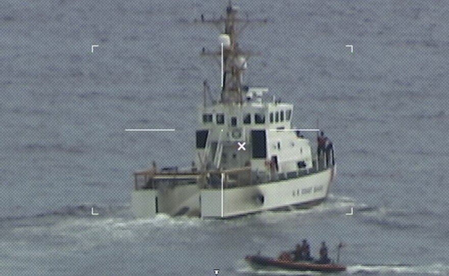 The crew of the Coast Guard Cutter Ibis searches for people missing from a capsized boat off the coast of Florida on Tuesday.