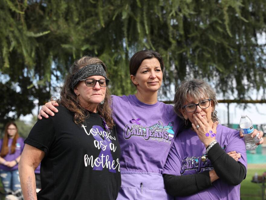 Jodie Williams, Calley's mother (left), and friends begin to cry as speakers remember Calley in October 2021. 