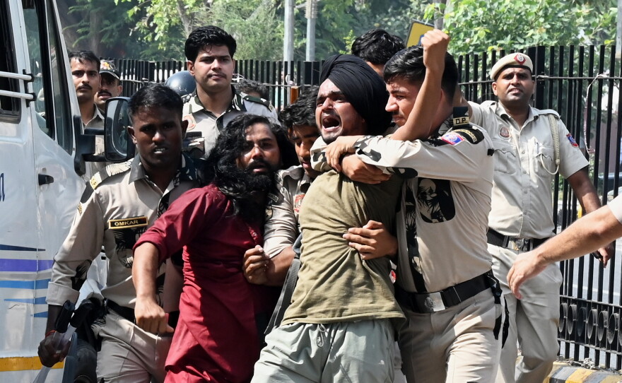 Policemen detain protesters during a youth demonstration demanding the resignation of the country's election chief Gyanesh Kumar, in New Delhi, India, Saturday, Oct. 10, 2026.