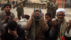 Egyptian anti-government demonstrators and members of the Egyptian Muslim Brotherhood movement pray in Cairo's Tahrir Square on Monday.