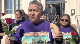 Janitorial employee Sofia Martinez holds a rose and piece of bread symbols of what she hopes to be able to afford to earn with a union contract: daily bread and a small luxury like a rose, Feb. 7, 2023. 