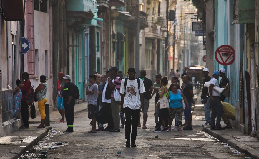 People line up in the street to buy bread in Havana, Cuba, Friday, March 13, 2026.
