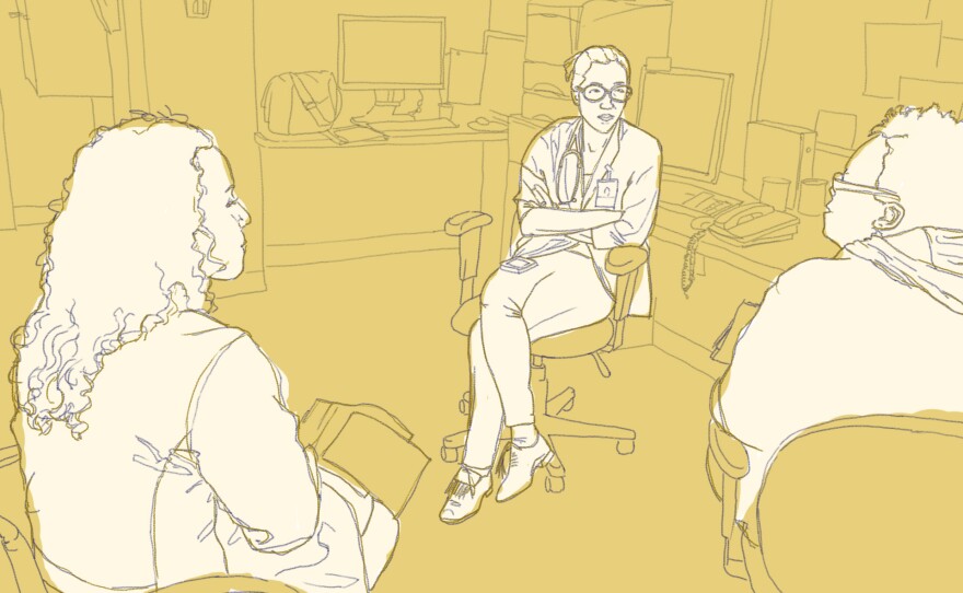 Doctors Lisa Puglisi and Emily Wang talk with a community health worker about the patients they're about to see at a clinic for ex-offenders in New Haven, Conn.