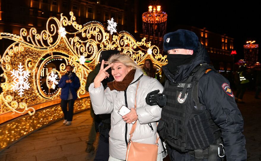 Police officers in Moscow detain a woman on Feb. 24 during a protest against Russia's invasion of Ukraine.