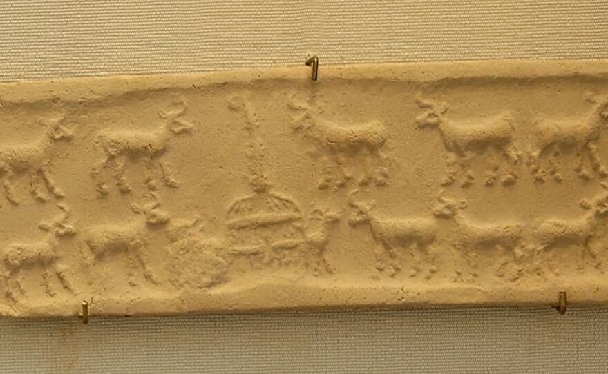 Cylinder seal and impression showing a cattle herd at the cowshed from Mesopotamia in the Uruk Period (4100 BC–3000 BC).