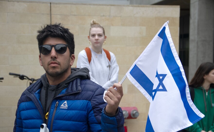 A person at a protest for Gaza holds an Israeli flag. UCSD in San Diego, Calif. March 6, 2024. 