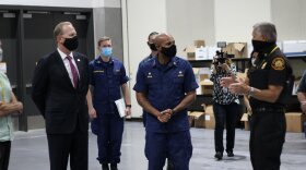 U.S. Surgeon General Jerome M. Adams (center) tours the Convention Center where homeless people are sheltered during the COVID-19 pandemic along with San Diego Mayor Kevin Faulconer and a San Diego Fire-Rescue official on Sept. 16, 2020.