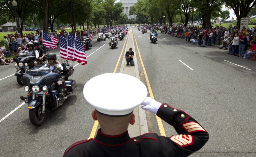 U.S. Marine Tim Chambers salutes participants in last year's Rolling Thunder motorcycle demonstration.