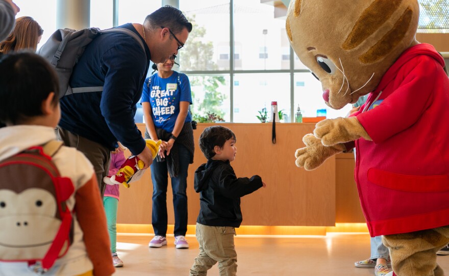 San Diego, CA - March 25: Daniel Tiger says hello to a little boy who attended story time for “Be My Neighbor Day” at the KPBS station on Saturday, March 25 in San Diego, CA.