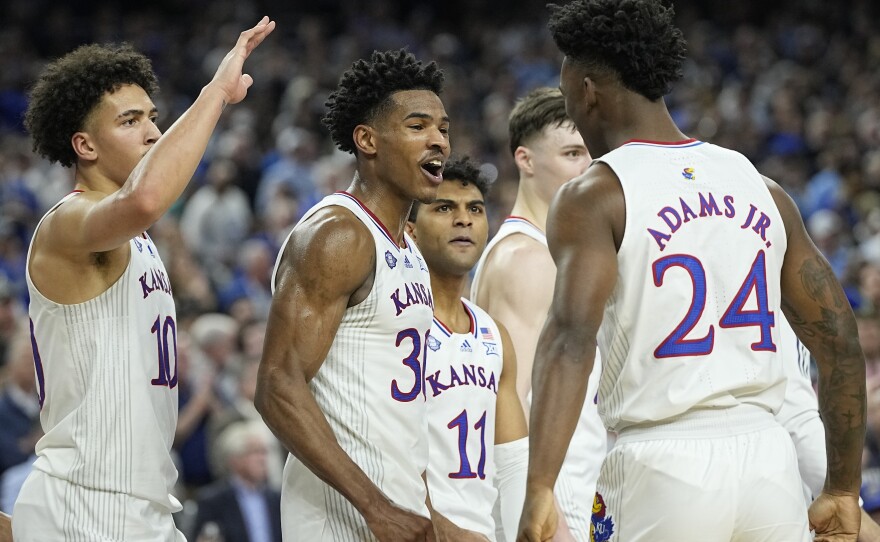 Kansas' Ochai Agbaji (30) celebrates with Jalen Wilson (10), Remy Martin (11) and K.J. Adams Jr. (24) after their win against Villanova in the semifinal round of the Men's Final Four NCAA tournament on Saturday in New Orleans.