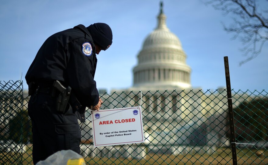 A US Capitol Policeman secures the area surrounding the west front of the US Capitol in Washington, D.C., on Jan. 5, 2013 as preparation are underway for U.S. President Barack Obama's second inauguration.