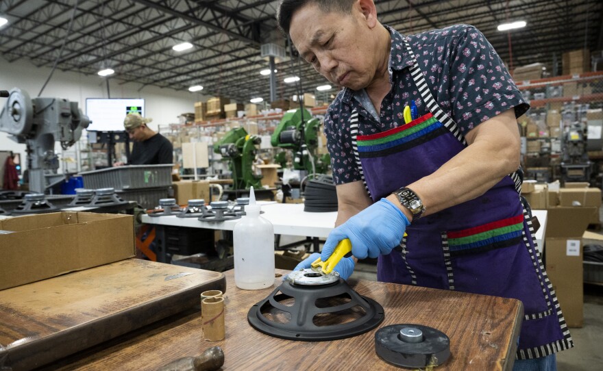 Louis Xiong assembles speaker baskets at the MISCO plant. Magnets are one of the few components of the speakers that the company has not regularly imported from China.