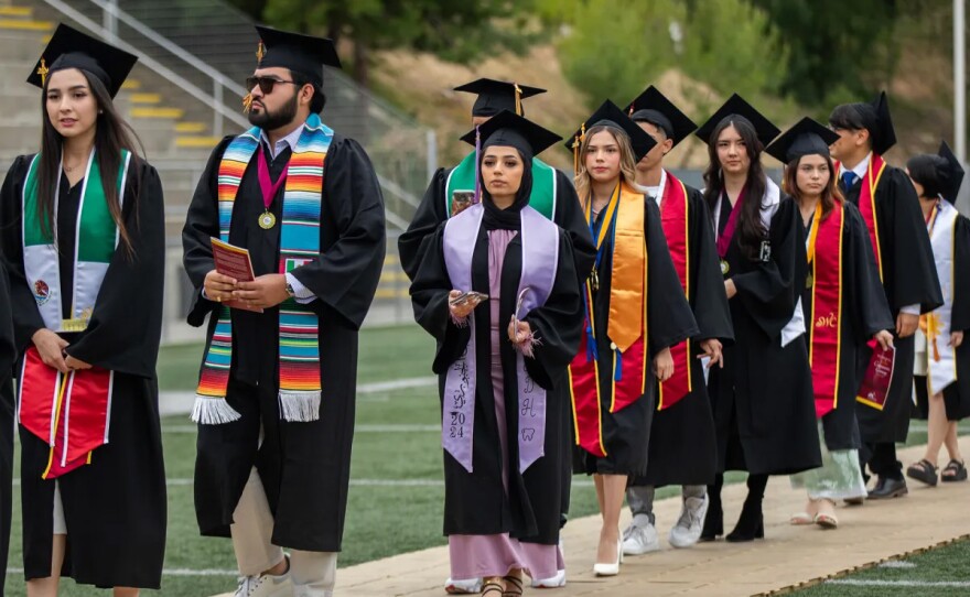 Students in academic regalia process into the stadium at the Southwestern College commencement ceremony in Chula Vista on May 24, 2024.