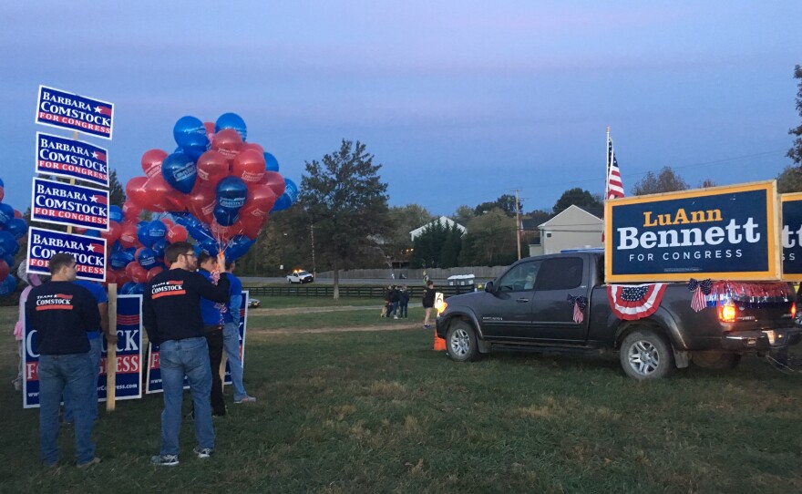 Volunteers from Republican Rep. Barbara Comstock's and Democratic challenger LuAnn Bennett's campaigns line up ahead of the Leesburg Halloween Parade in Loudon County, Va.